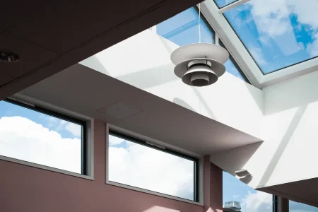 low-angle-shot-lamp-hanging-inside-building-with-glass-ceiling